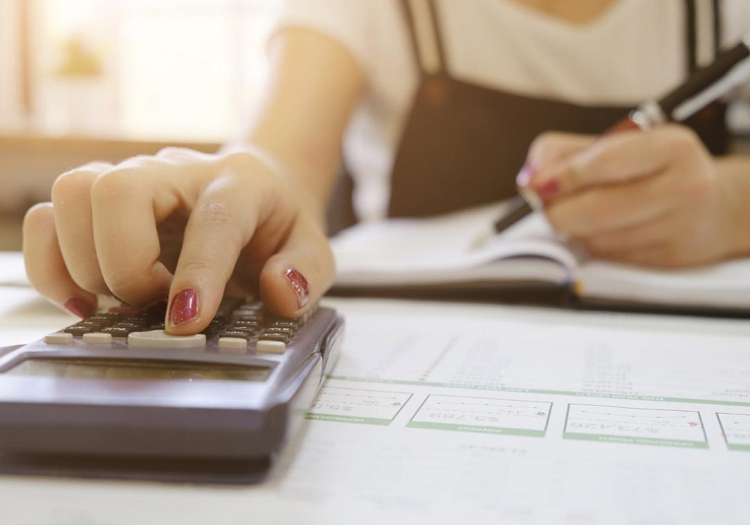 Closeup of teen studying with calculator