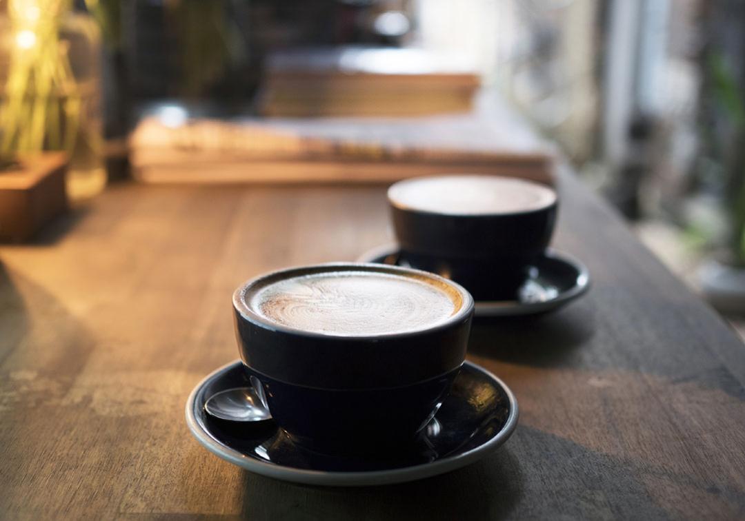 Two flat white coffees being served at a cafe in Brisbane.