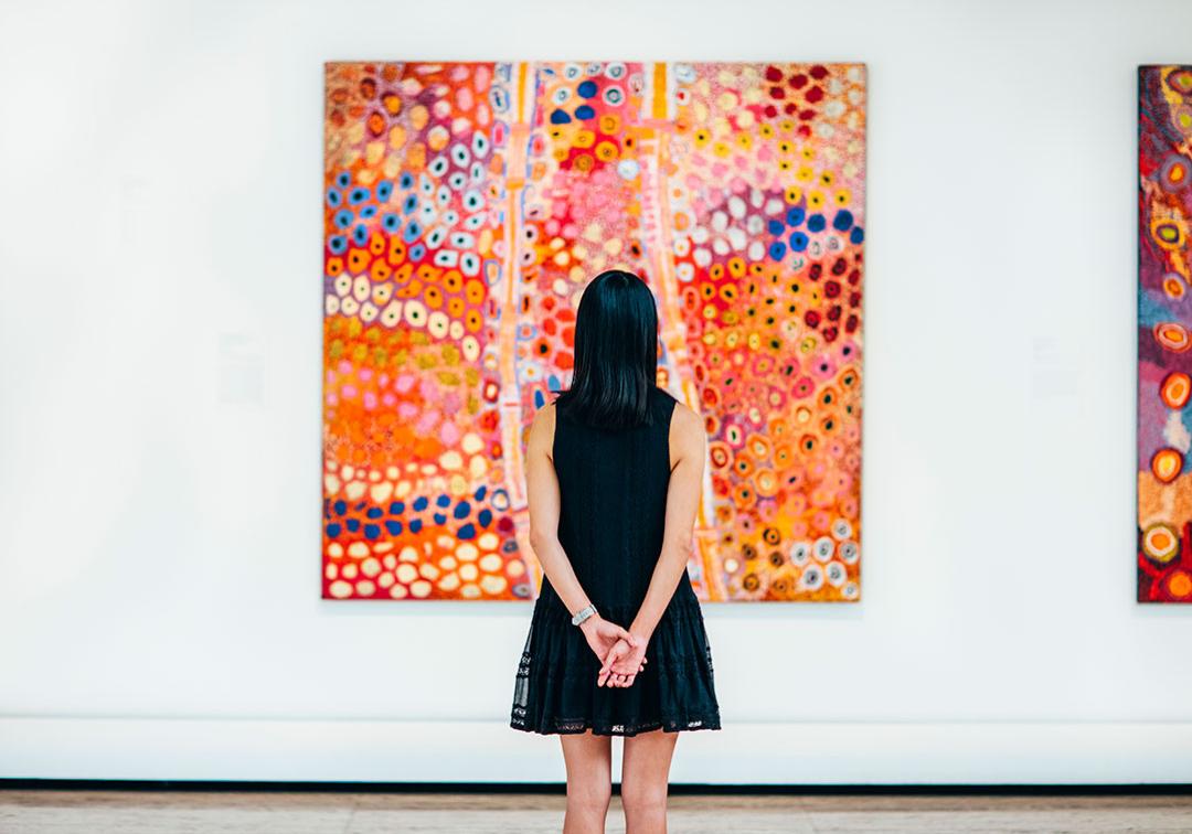 A patron at Queensland Art Gallery, appreciating a painting.