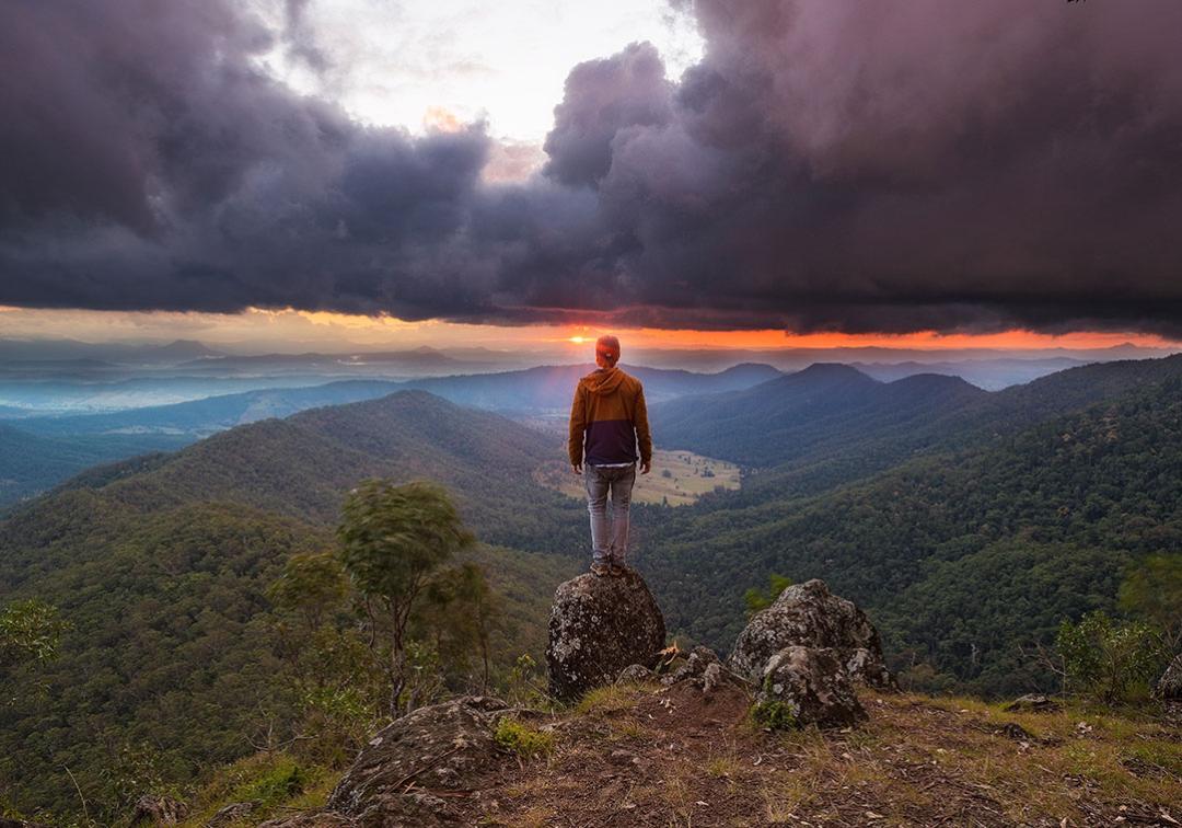 A hiker looking out from Lukes Bluff over the Scenic Rim, south of Brisbane.
