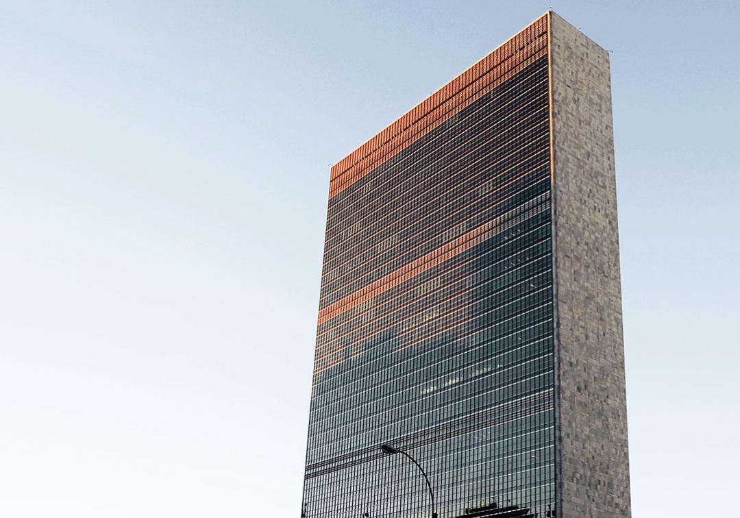 The headquarters of the United Nations in New York City at sunset.