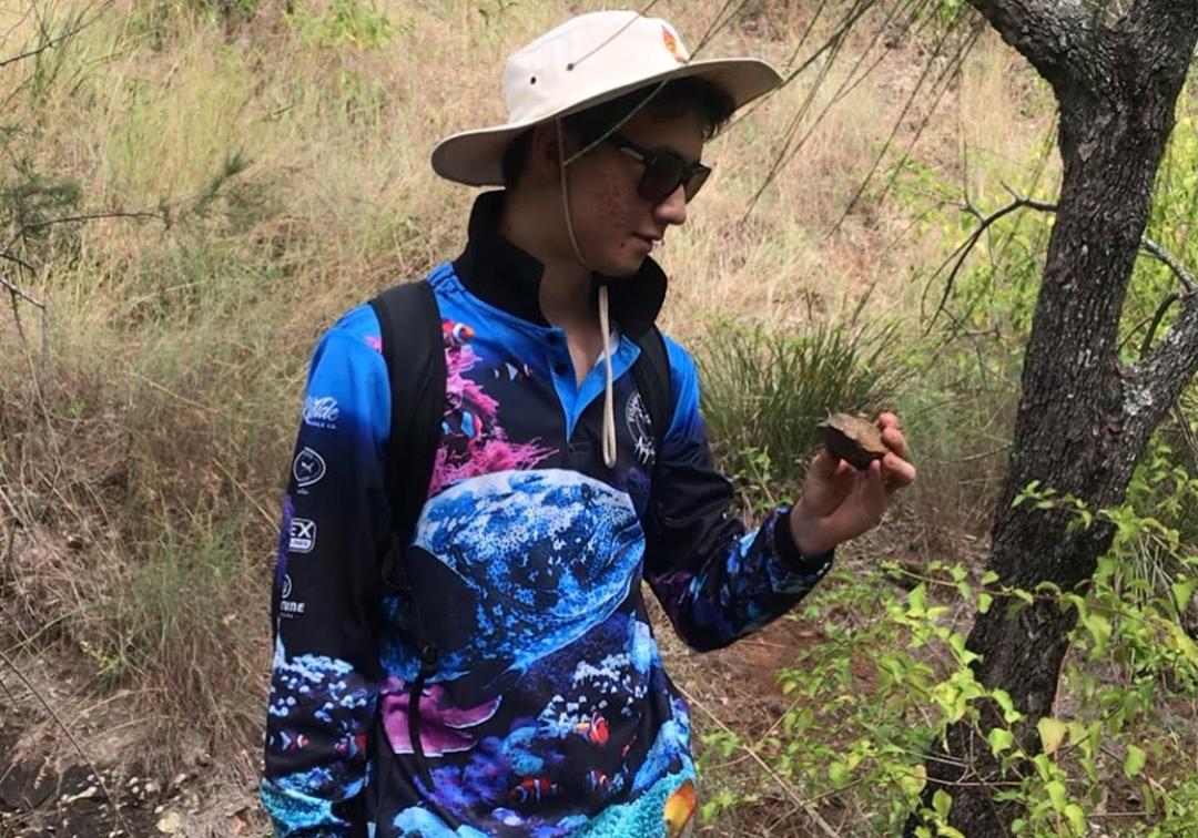 Eric Ward inspects rock while on bush walk