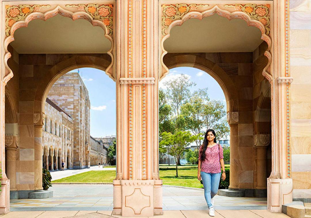 Female student walking through one The University of Queensland's St Lucia campus arches