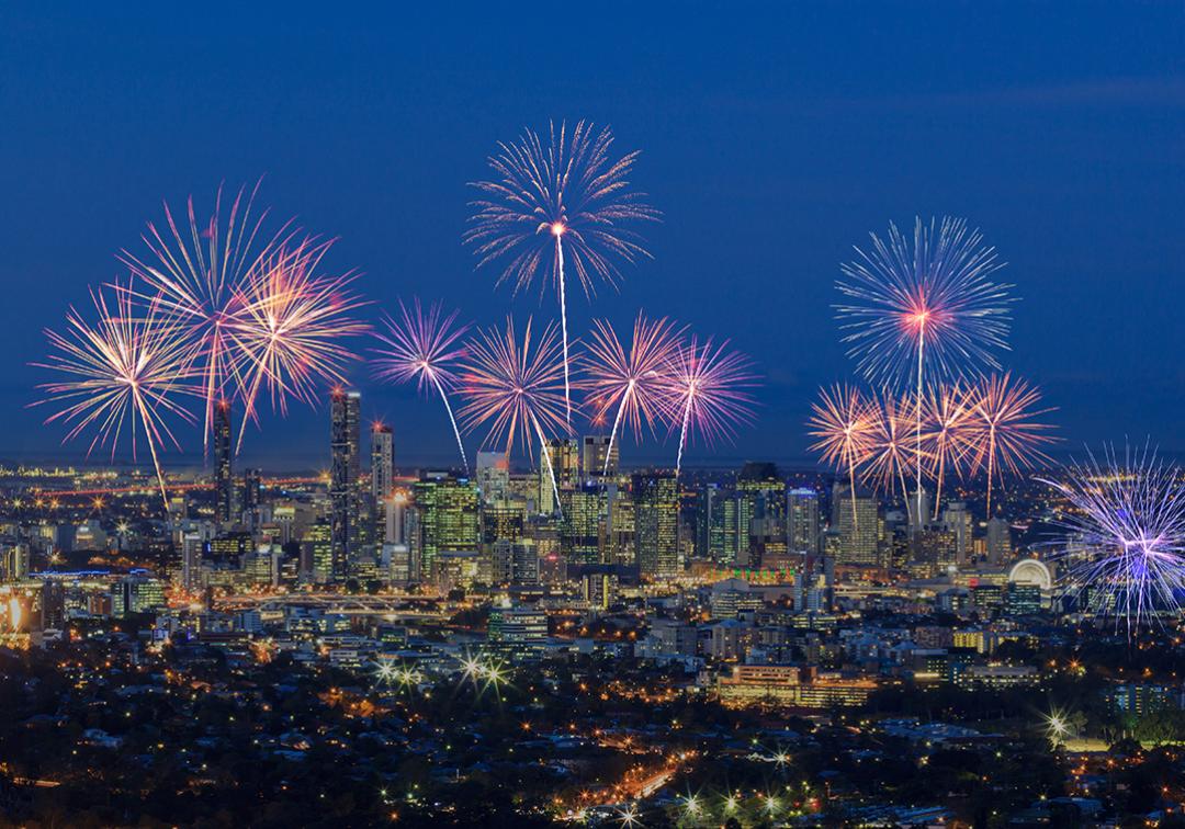 Image of Brisbane at night with fireworks in the sky
