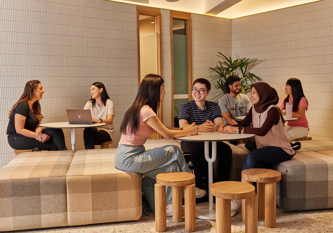 UQ students sitting at a table chatting