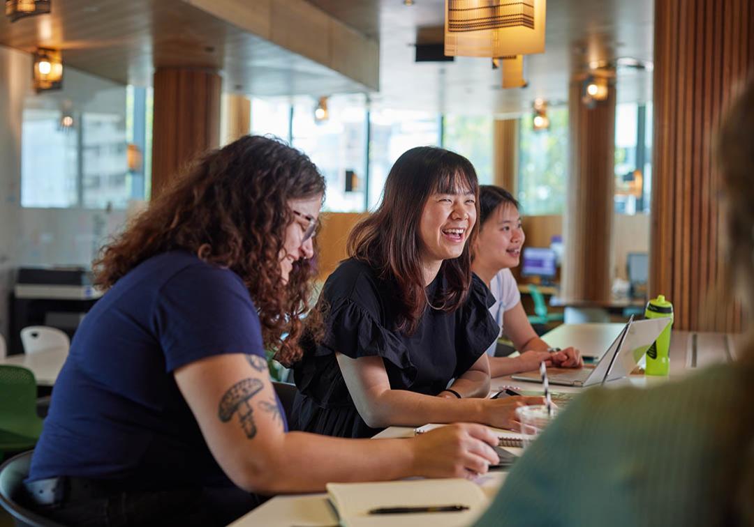 UQ students at desks with laptops in classroom