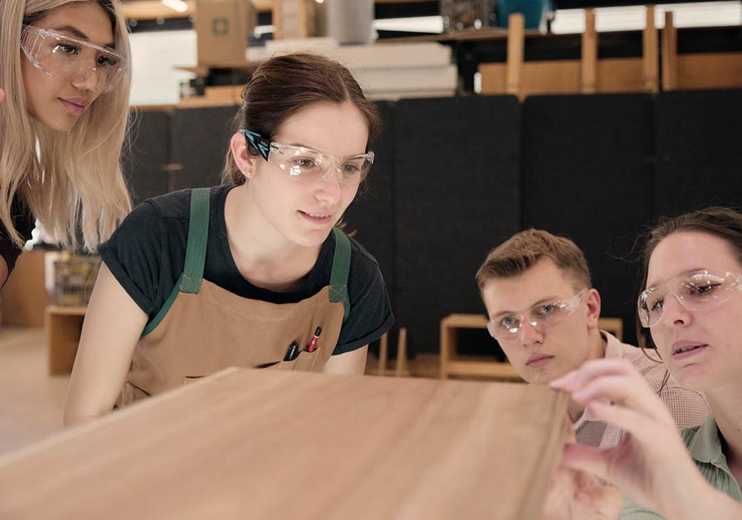 UQ design students inspect a plank of wood