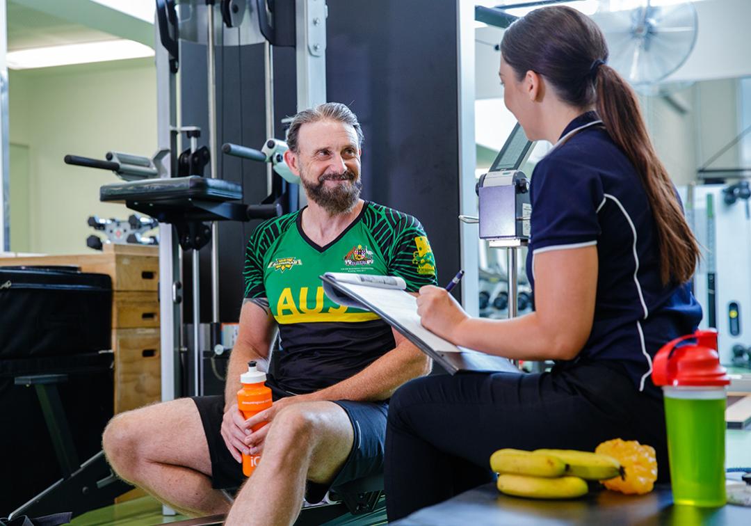 Sports dietitian with a client in the gym