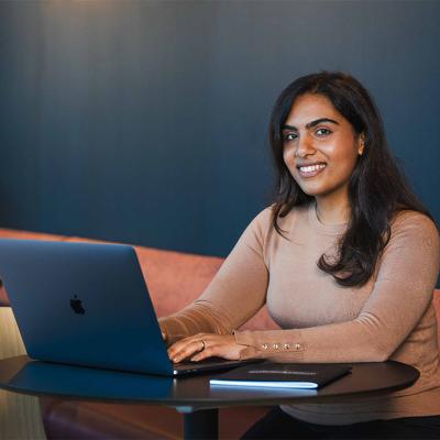 Bachelor of Commerce student working on a laptop.