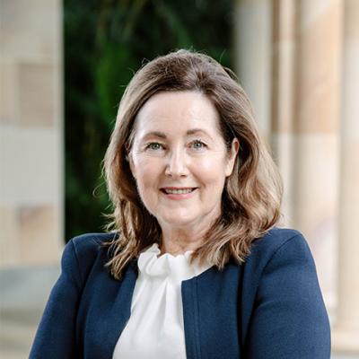 A headshot of Professor Janet McColl-Kennedy. She is wearing a light coloured high-neck blouse and a navy suit jacket. She has shoulder length light brown hair. 
