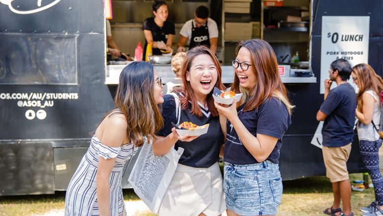 International students standing infront of food trucks on campus at UQ 