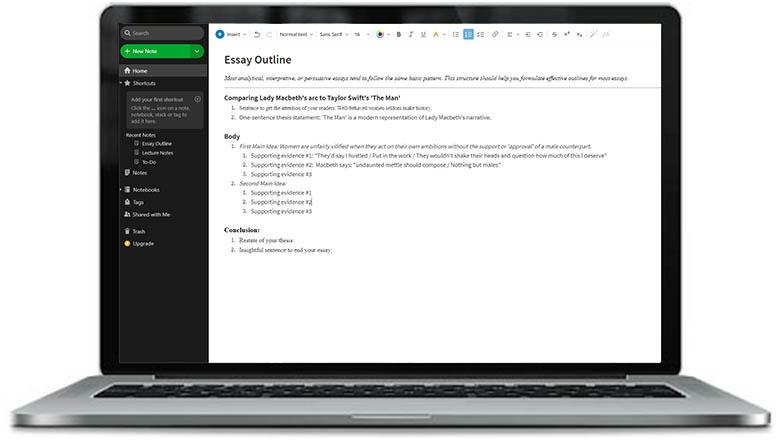 A laptop screen displays the Evernote interface containing an essay outline in the text box