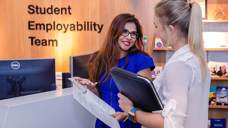 A member of UQ's Student employability team discusses options with a student