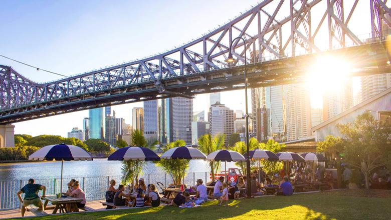 People relaxing by the riverside at Howard Smith Wharves (image courtesy of Brisbane Economic Development Agency).