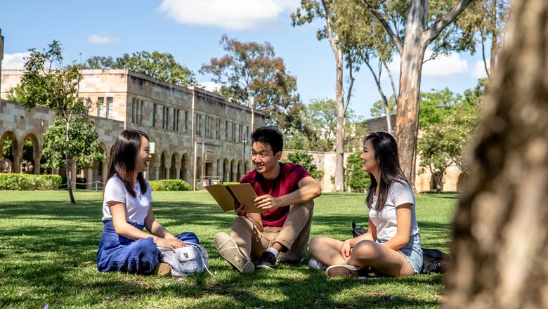 Students sitting on The University of Queensland's Great Court, St Lucia campus, Brisbane, Australia.