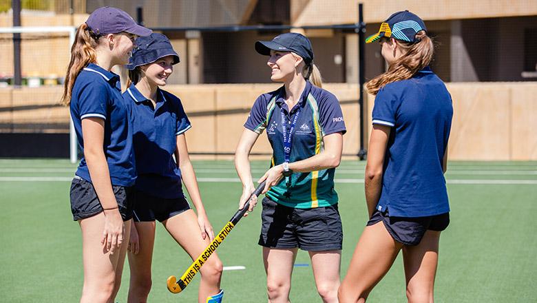 Life after high school. High school students learning hockey at UQ.