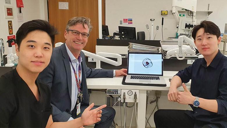 Ryan Choi, Sean Choi and Prof Ove Peters sit in a lab with a laptop