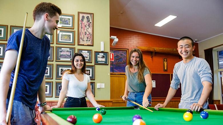 Students play pool in a UQ Residential College common room