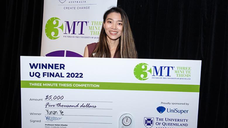 Rainie standing with her 3MT cheque