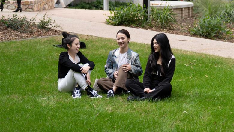 Anny sitting on the grass with friends