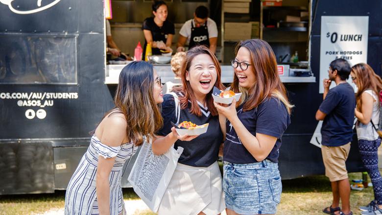 International students standing infront of food trucks on campus at UQ 