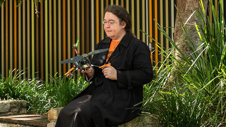 Dr Pauline Pounds gazes down at the drone she has invented