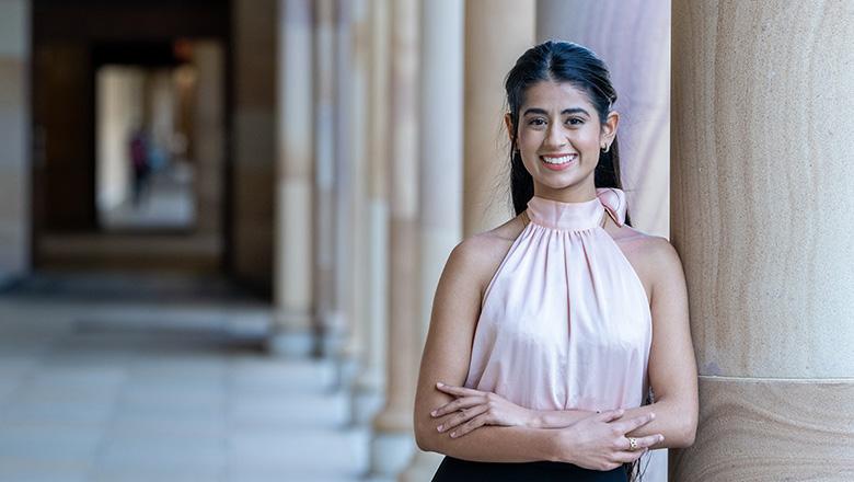 Ramneet Ubbi, UQ Master of Audiology Studies student stands in St Lucia campus' sandstone cloisters