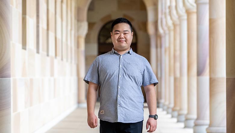 Yuxuan Liu, UQ Master of Public Health student stands in the sandstone cloisters of The Great Court at St Lucia campus