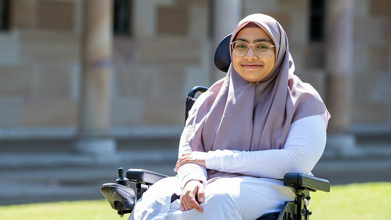 Aisyah Ardani, UQ Master of Educational Studies student, sits in UQ St Lucia's Great Court