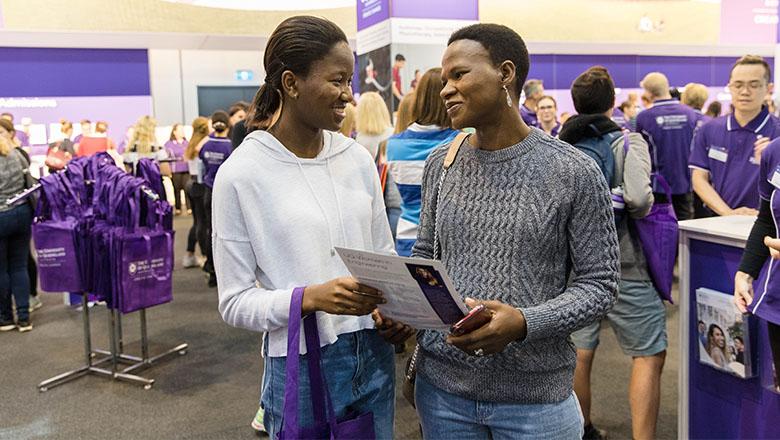 Mother and Daughter look at a brochure at TSXPO