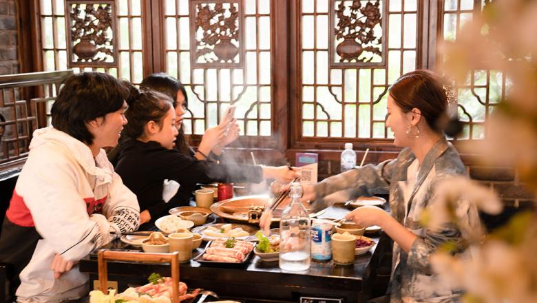 Four friends having hotpot at a restaurant