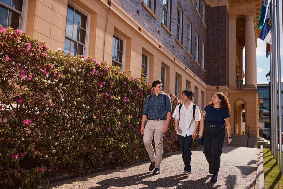 UQ students walk down pathway at Herston campus