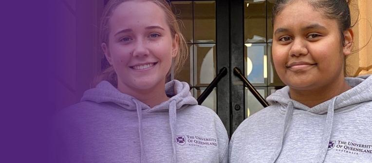 2 students in UQ hoodies smiling at the camera. 