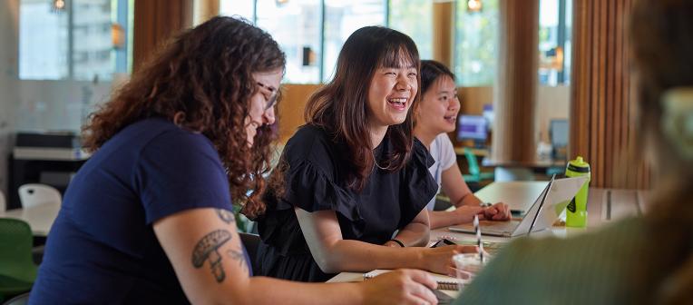 UQ students at desks with laptops in classroom