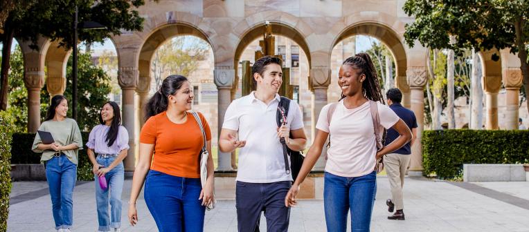 Group of international students walking through the Great Court of The University of Queensland's St Lucia campus.