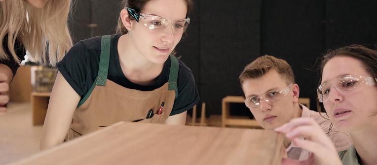 UQ design students inspect a plank of wood