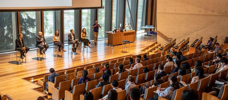 A lecture theatre with a panel of speakers