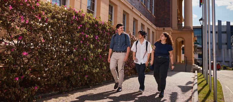 UQ students walk down pathway at Herston campus