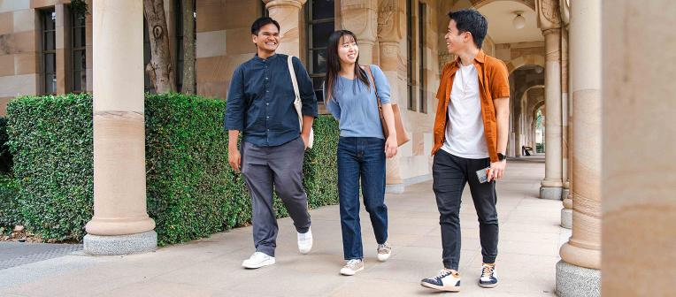 UQ students walk through the sandstone cloisters at St Lucia campus