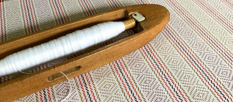 a loom on top of a blanket