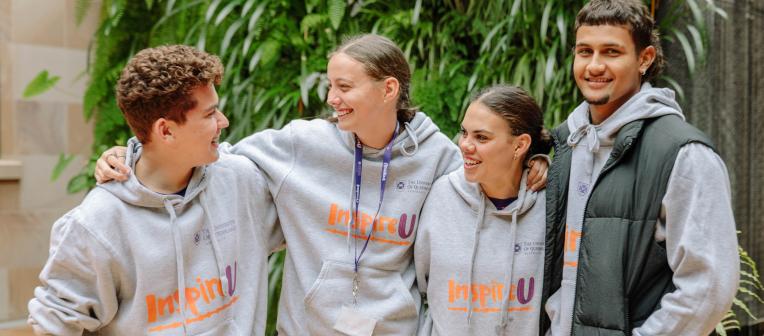 4 students wearing InspireU hoodies 