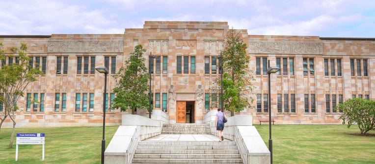 Outside view of the exterior of the Forgan Smith Building and the UQ Law School, featuring sandstone and windows