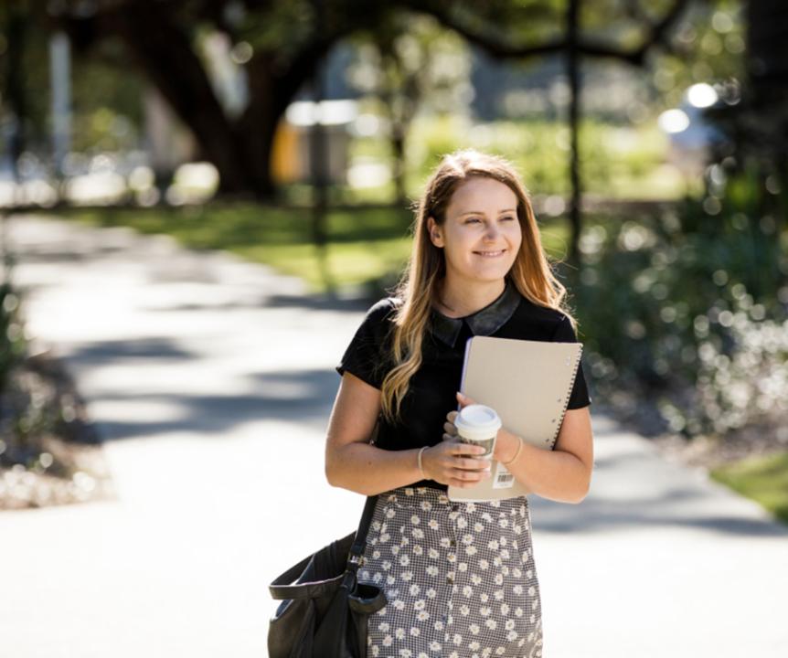 Female student walking on campus grounds