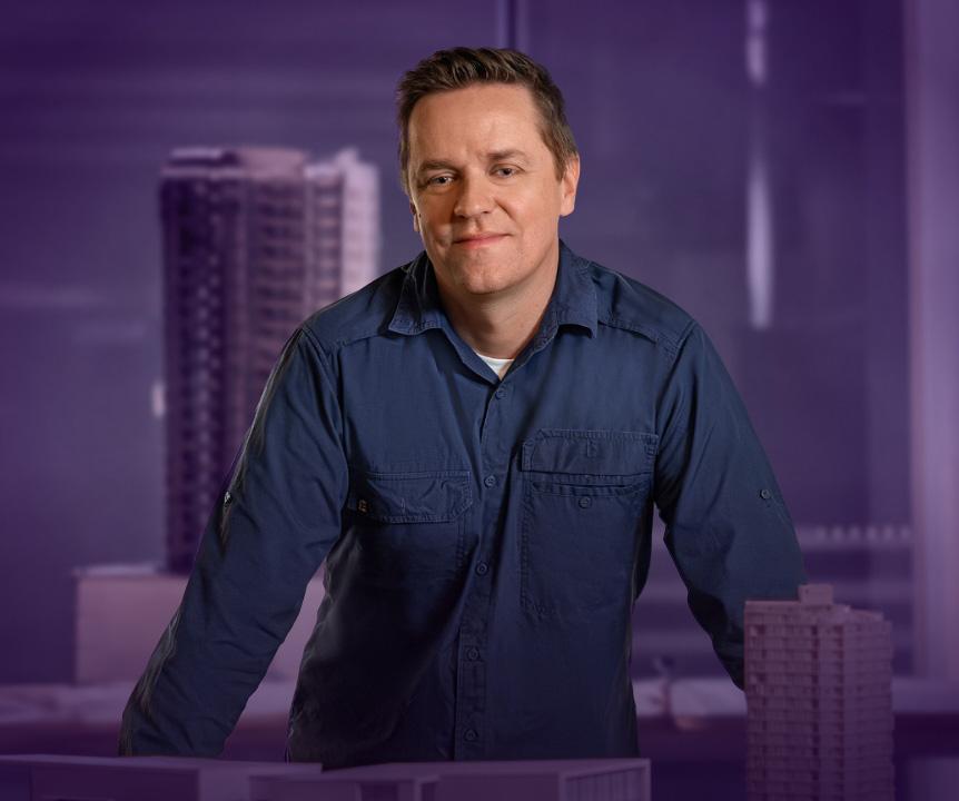 Mature man with blue shirt and purple background