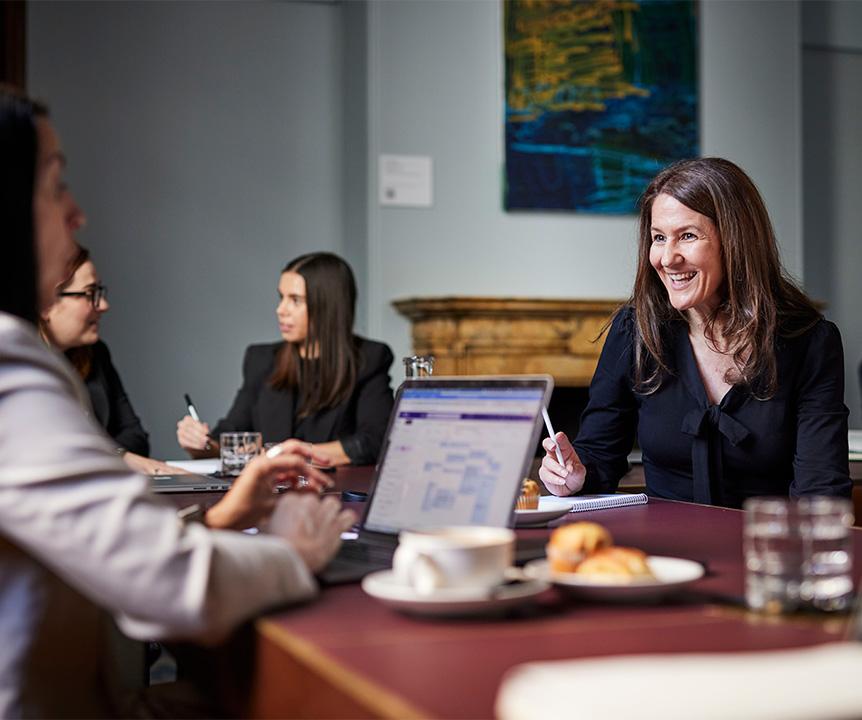 Two people sit at a table in UQ's 308 Queen Street building