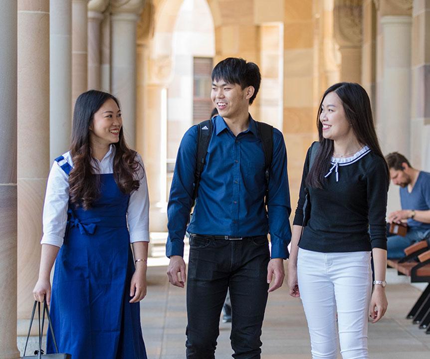 Three students walking through the Great Court.