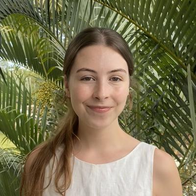 Annabelle Harriman standing in front of a palm frond