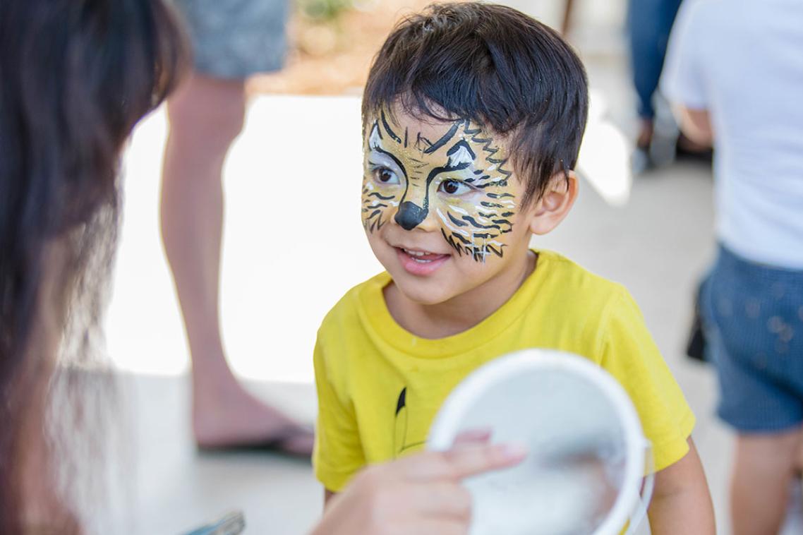 A child has his face painted at Margaret Cribb Child Care Centre on St Lucia campus.