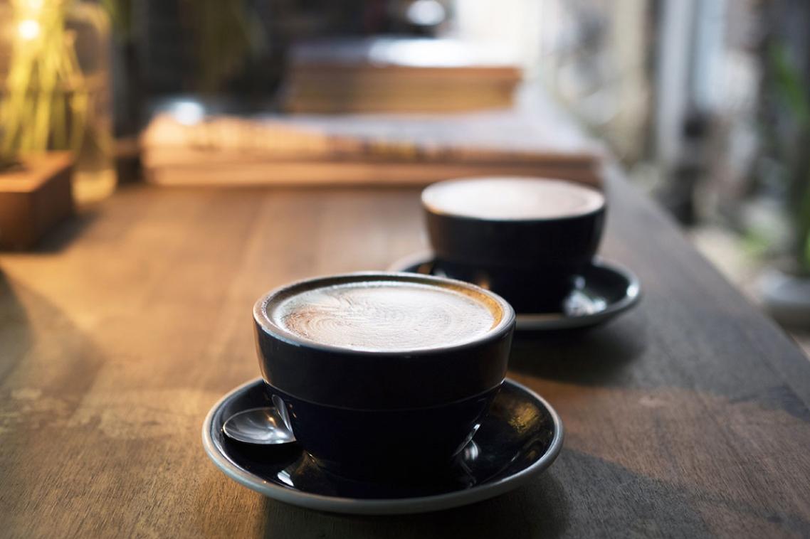 Two flat white coffees being served at a cafe in Brisbane.