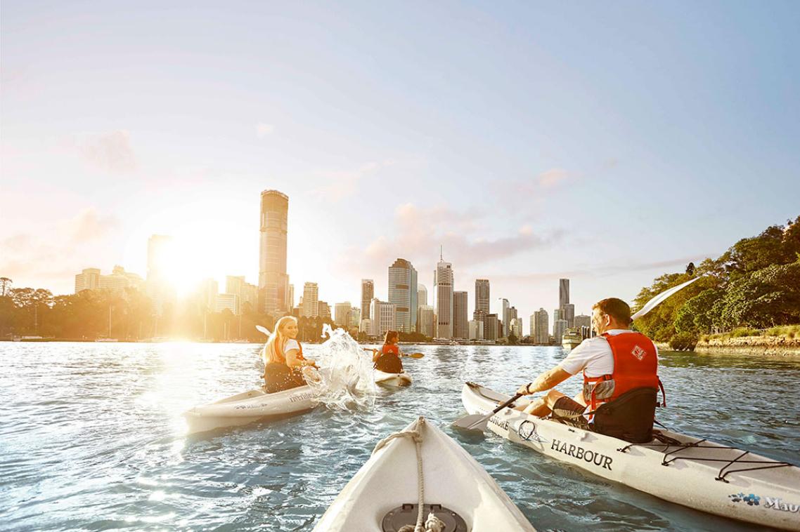 A group of people kayaking on the Brisbane River.